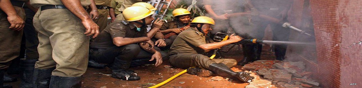 Firefighters unleash water to douse flames from an opening in the wall of the Advance Medicare And Research Institute (AMRI) hospital in Kolkata on December 9, 2011.
